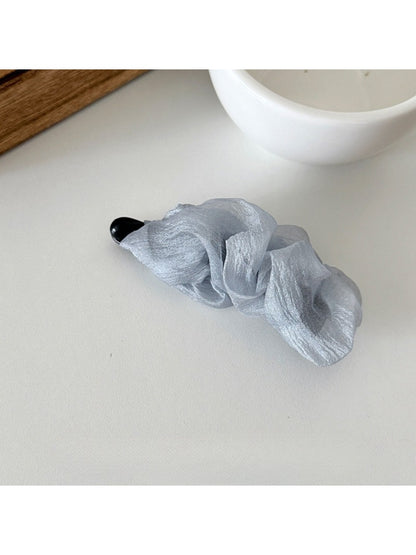 Beau tulle ruffle high ponytail claw clip held in hand to show size