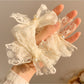 Close-up of white lace bow detail on scrunchie