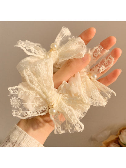 Close-up of white lace bow detail on scrunchie
