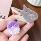 Beau colorful claw clip with shark and octopus print on a white background