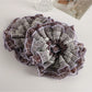 Vintage purple floral scrunchie displayed on a white background showing full circular shape