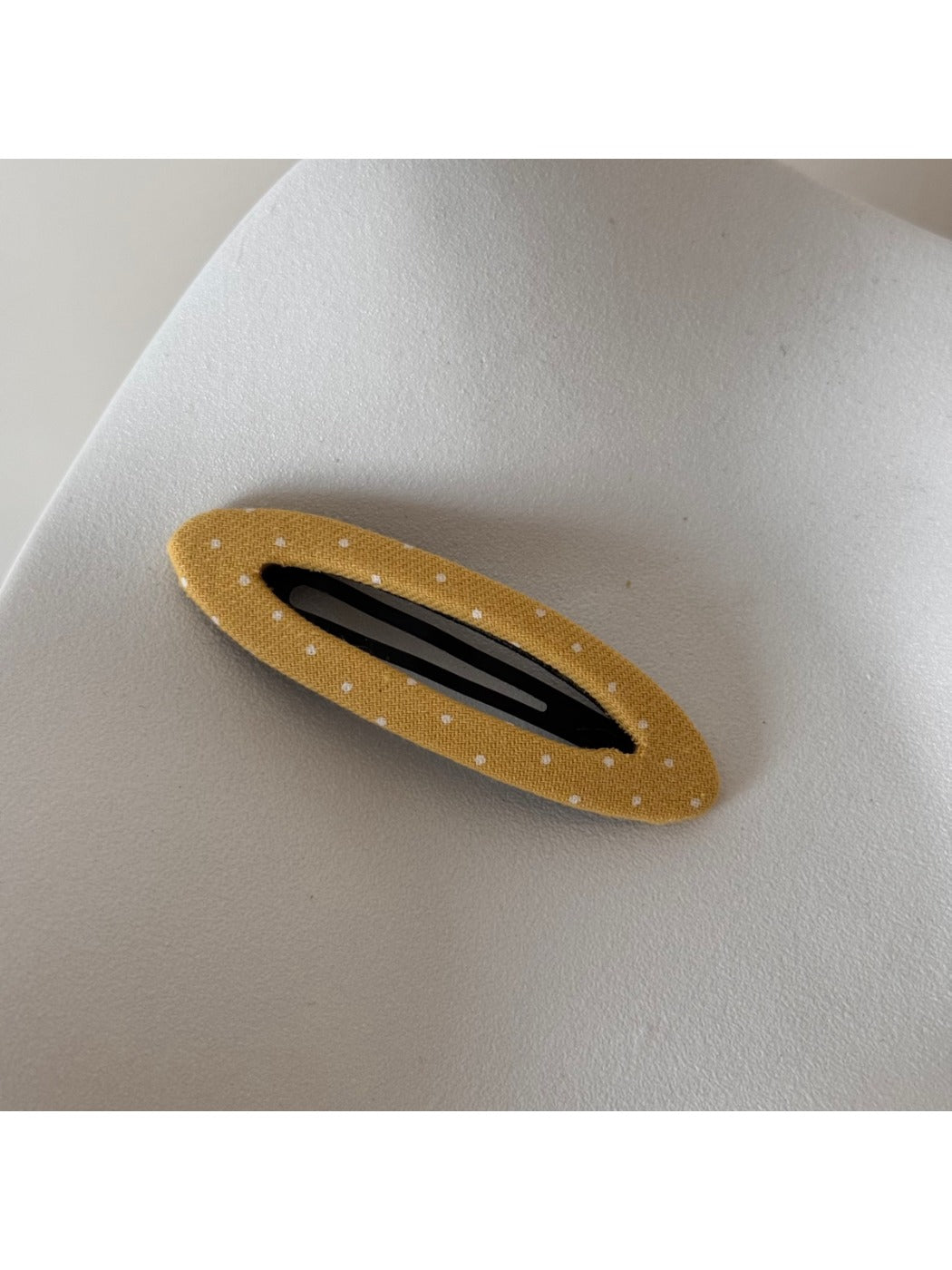 Beau hair clip held between fingers showing size and detail