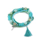 Side view of Lovra multi-row beaded bracelet highlighting tassel charms