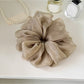 Gifty ruched scrunchie styled with casual outfit on a mannequin