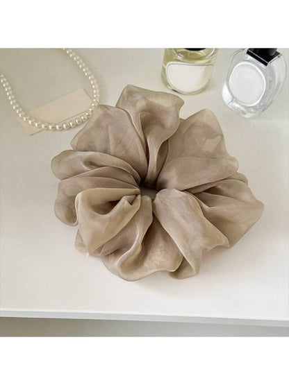 Gifty ruched scrunchie styled with casual outfit on a mannequin
