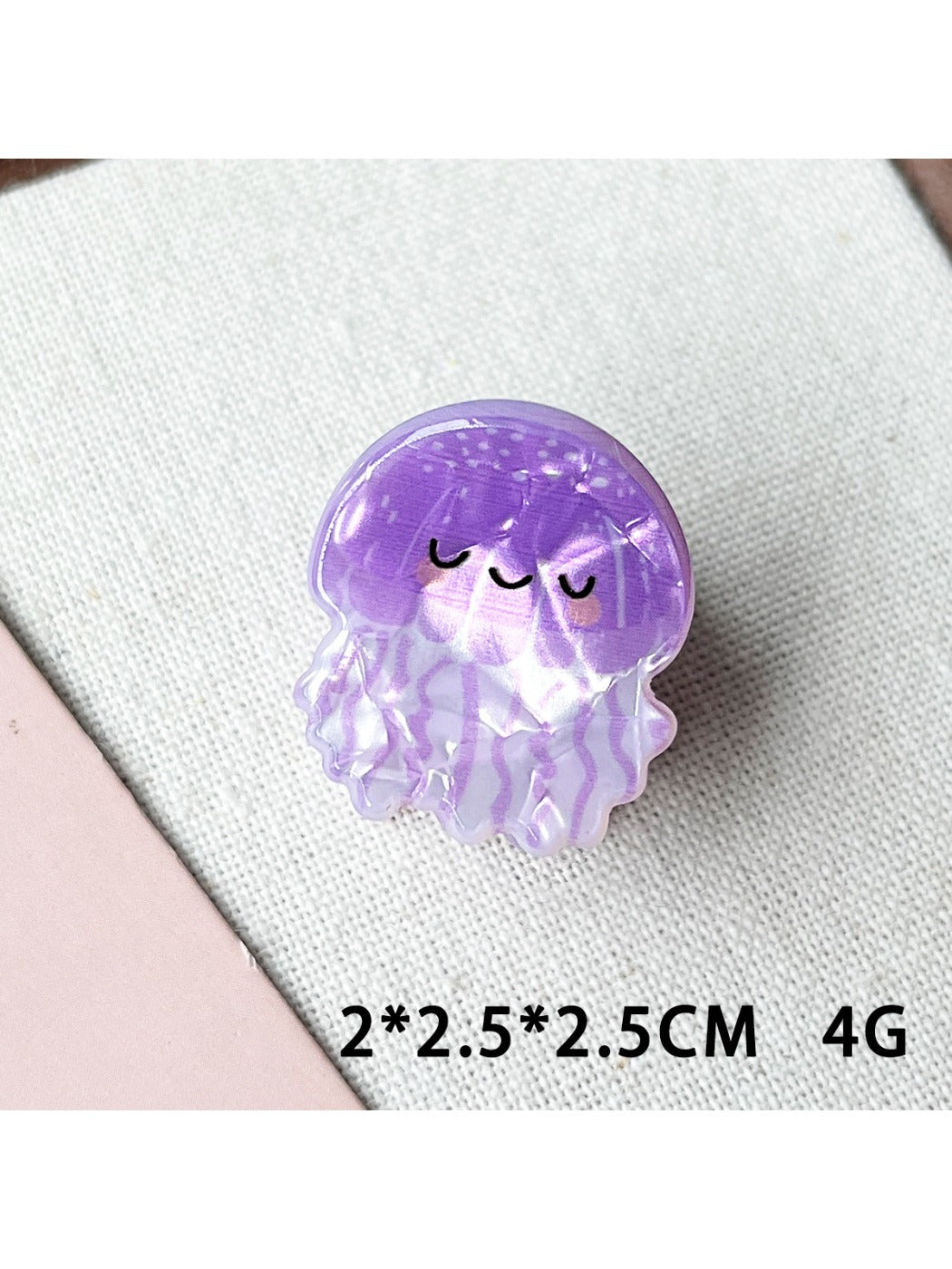 Beau claw clip held in hand displaying colorful shark and octopus artwork