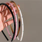 Close-up of Gifty vintage thin headband showing fabric detail and stitching