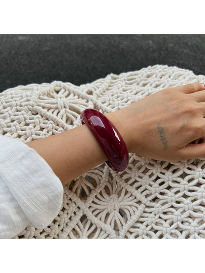 Model wearing Lovra red ombre link bracelet and ring on wrist and finger