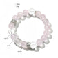 Lovra pink and white crystal beaded bracelet coiled on a reflective surface