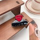 Beau medium heart shaped half circle claw clip shown from top angle on white background