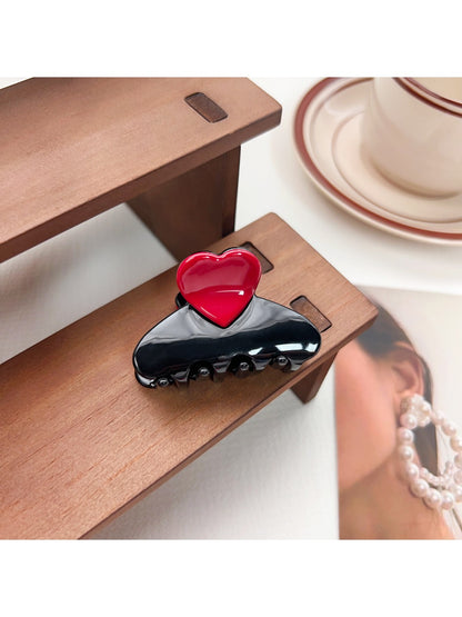 Beau medium heart shaped half circle claw clip shown from top angle on white background
