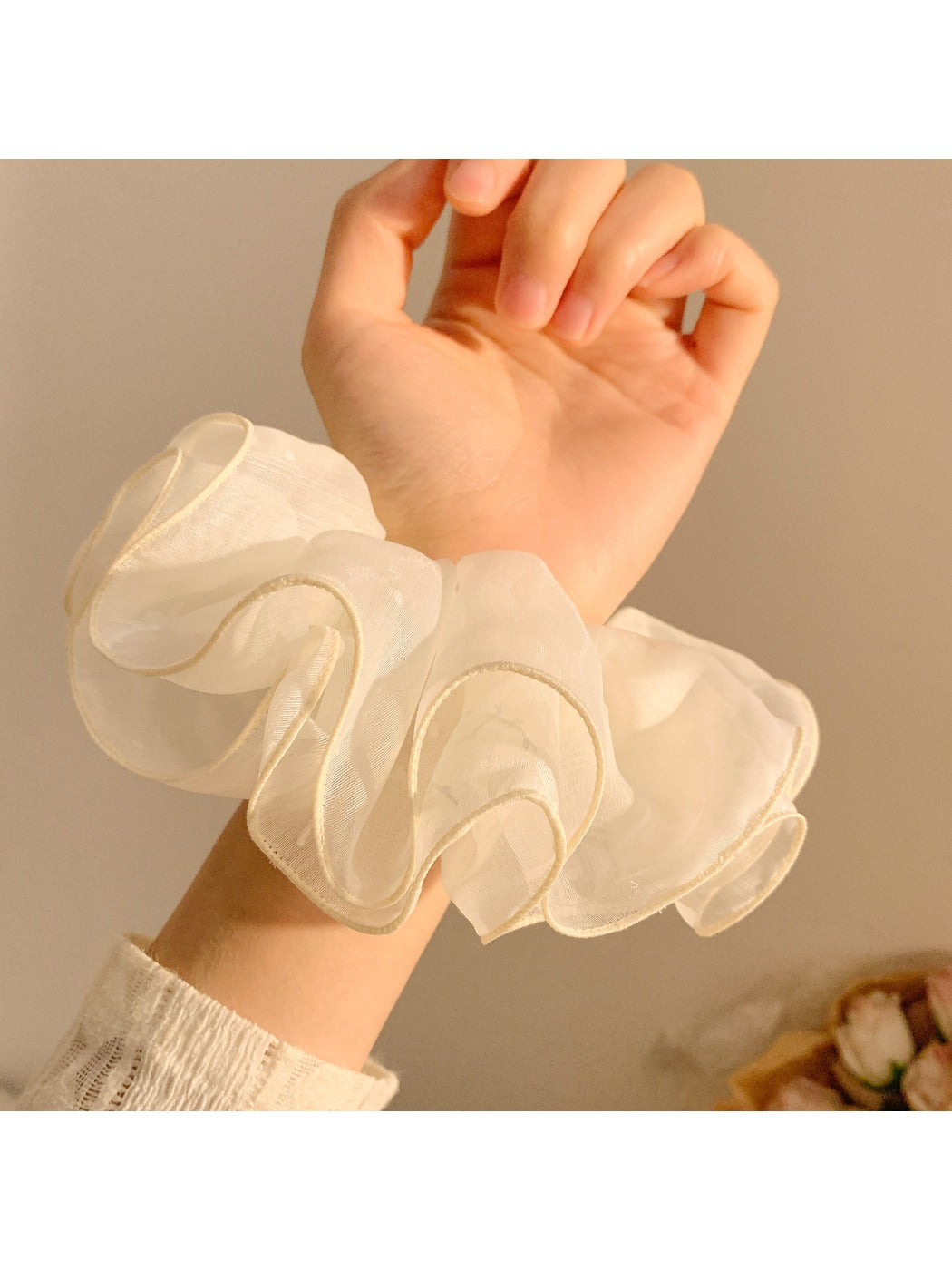 Side view of pastel pink tulle scrunchie highlighting layered design