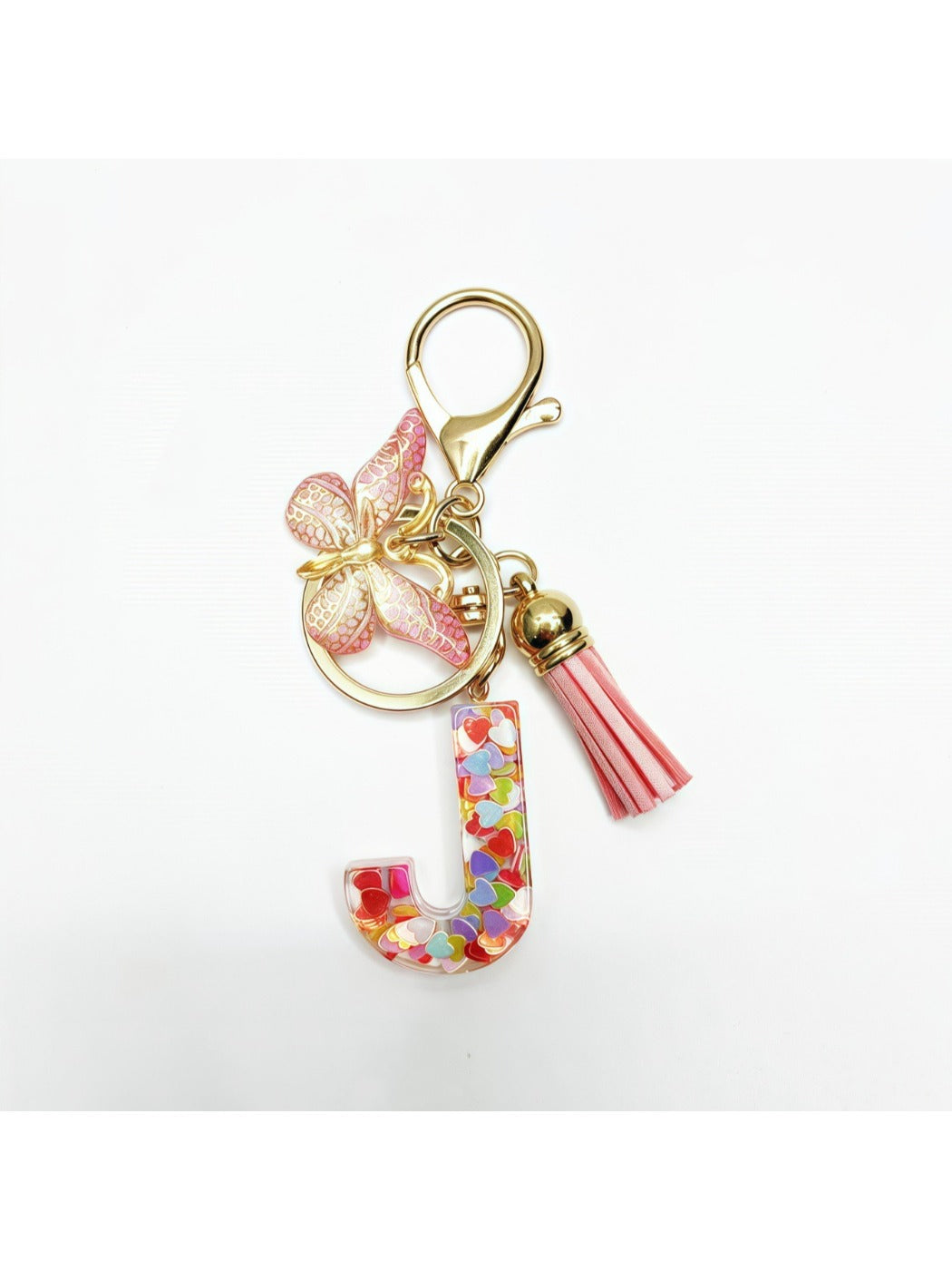 Butterfly letter pendant keychain held between fingers showing size