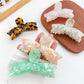 Beau sweet bow shaped hair claw clip in soft pastel pink on white background
