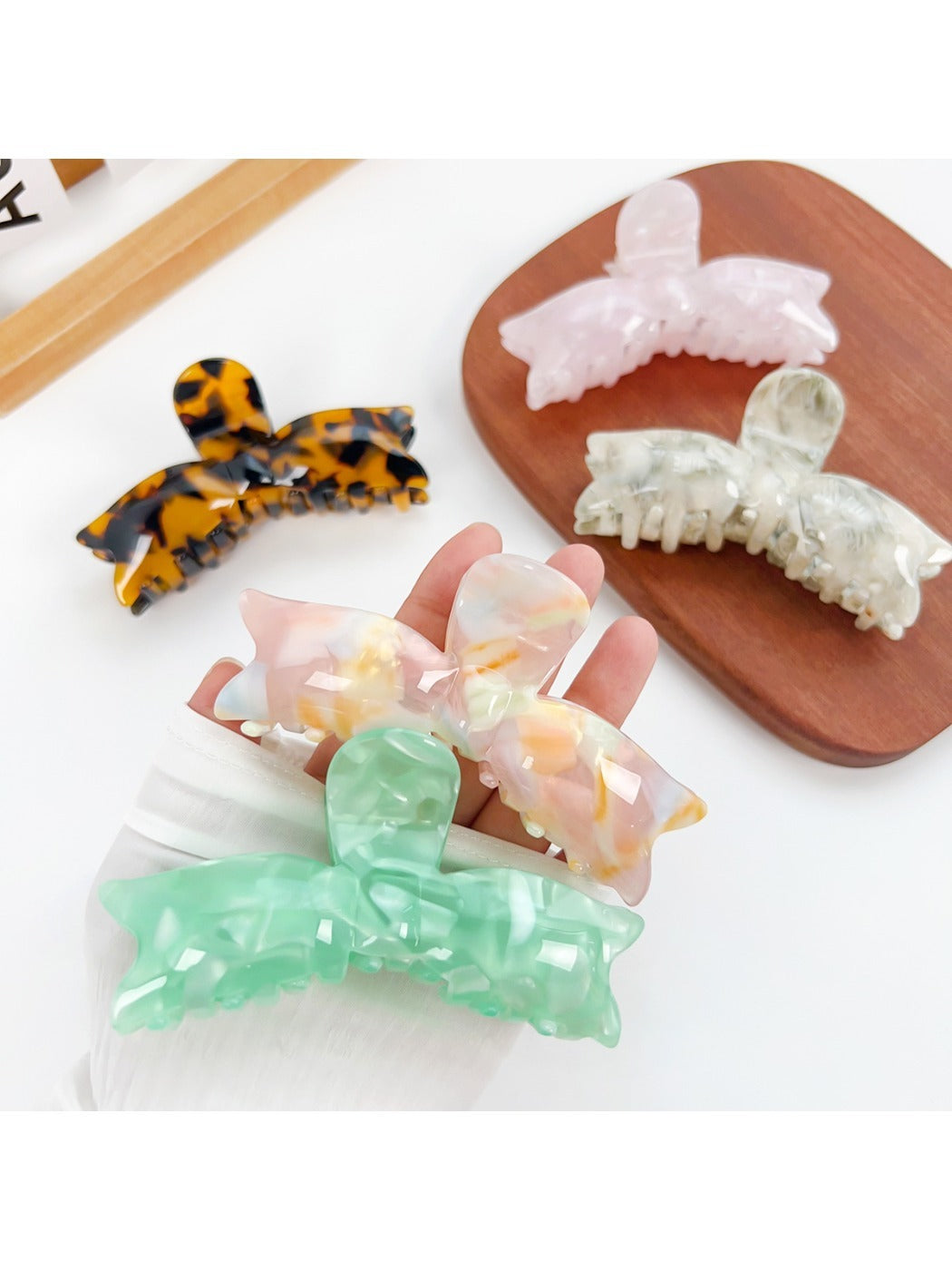 Beau sweet bow shaped hair claw clip in soft pastel pink on white background