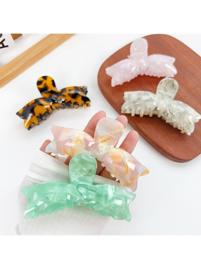 Beau sweet bow shaped hair claw clip in soft pastel pink on white background