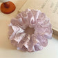 Sweet purple double scrunchie with cutout design on a white background