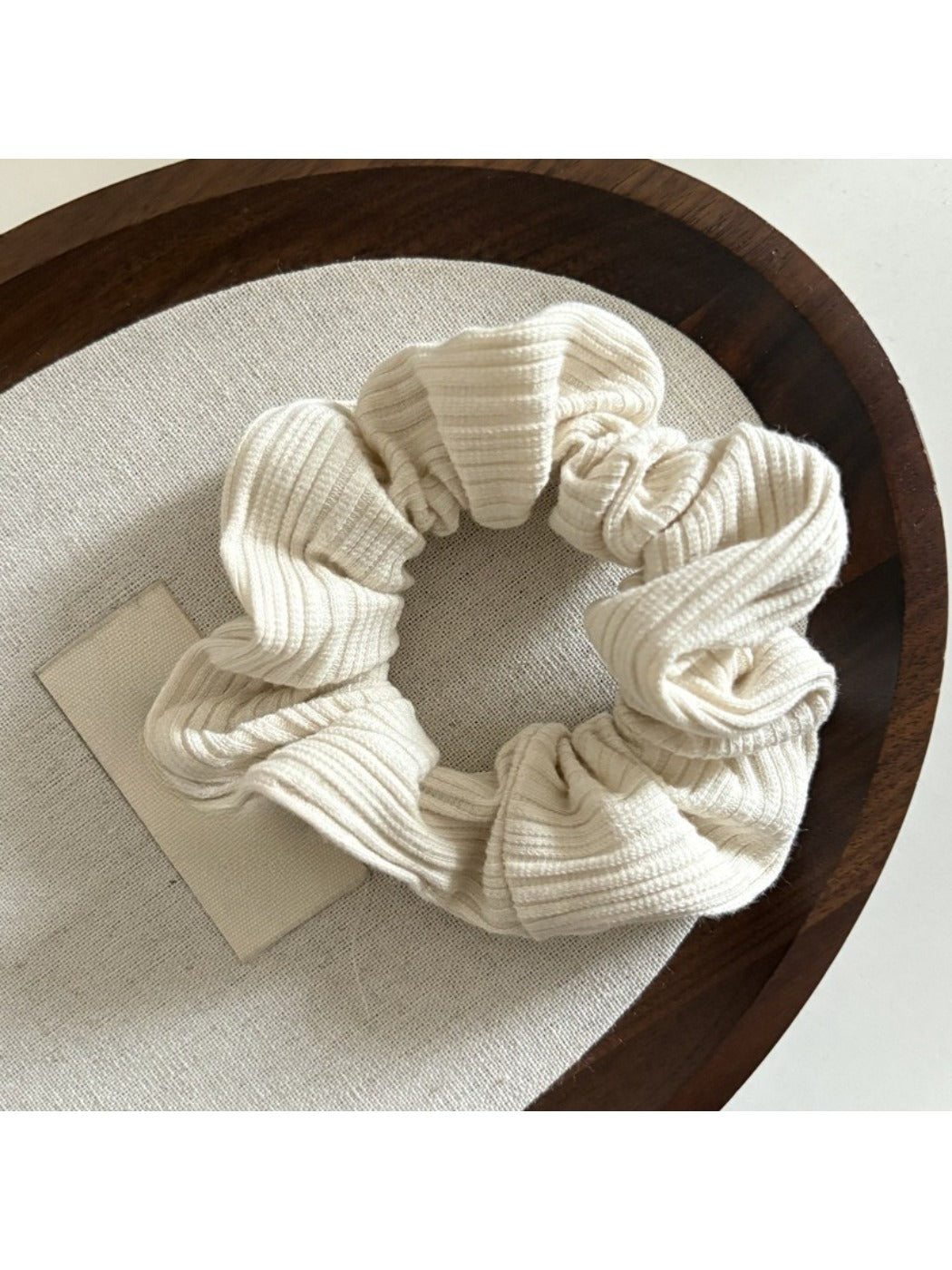 Top view of Gifty striped scrunchie highlighting elastic band inside