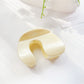 Beau hair claw clip in neutral color displayed with matching accessories