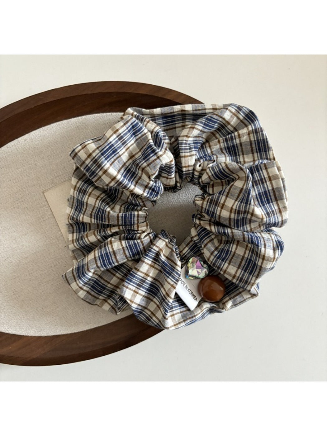 Flat lay of Gifty vintage plaid bow scrunchie with bow detail visible