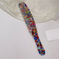 Camerow long handle hair comb with teeth partially embedded in hair strands