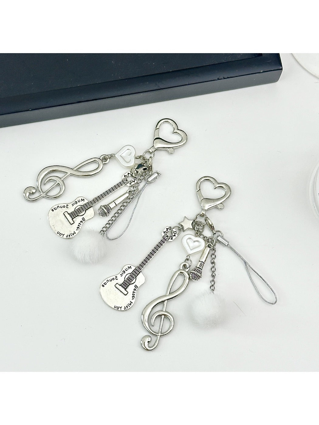 Close-up of Keypus music note keychain showing detailed musical note charm on silver keyring