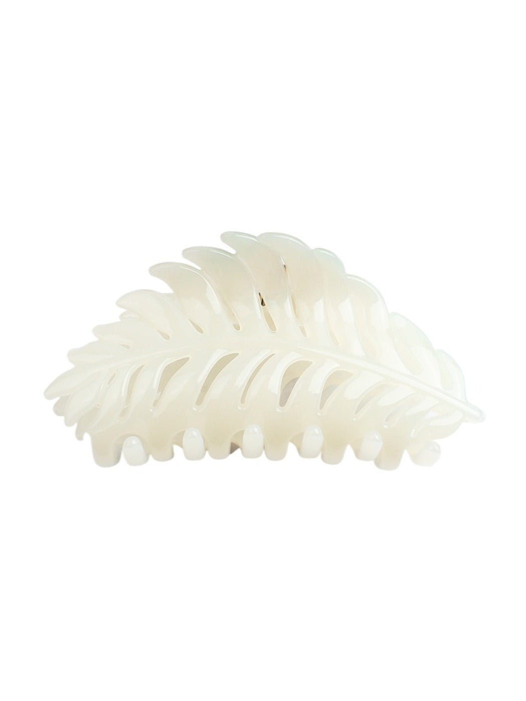 Beau leaf hair clip resting on a fabric surface