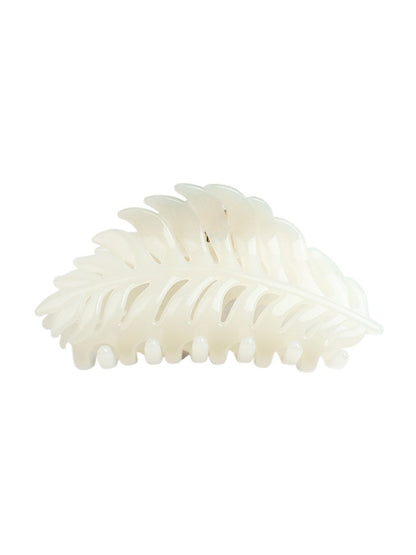 Beau leaf hair clip resting on a fabric surface