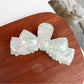 Beau classic bow shaped hair claw clip angled to show clip teeth
