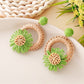 Model wearing Earedge raffia daisy shaped stud earrings close to ear
