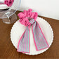 Scrunchie in natural light showing vibrant magenta colors