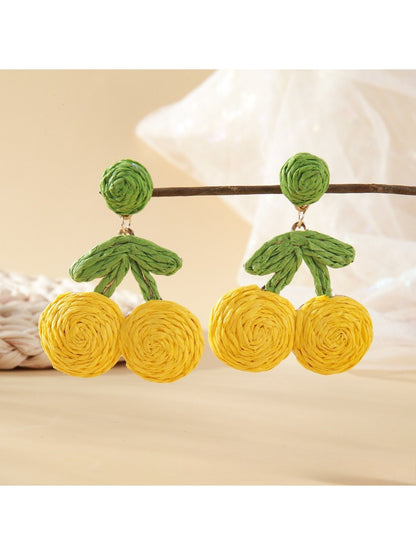 Earrings displayed hanging on a white card with raffia cherry design