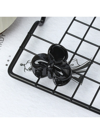 Beau small butterfly claw clip held in hand to show size and scale