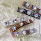Set of colorful square hair clips arranged on a white background