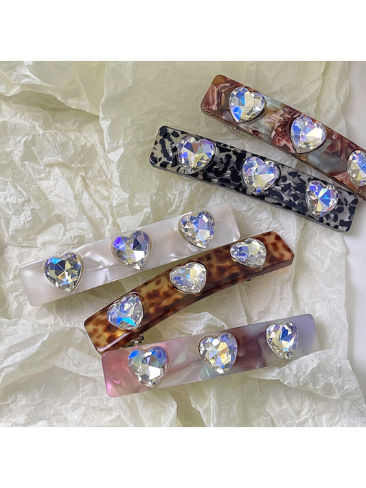 Set of colorful square hair clips arranged on a white background