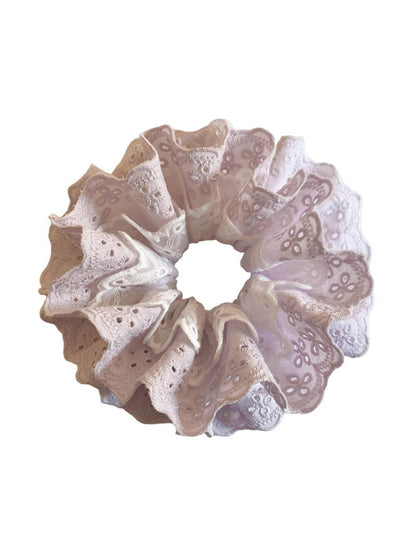 Side view of sweet purple double scrunchie highlighting texture and cutouts