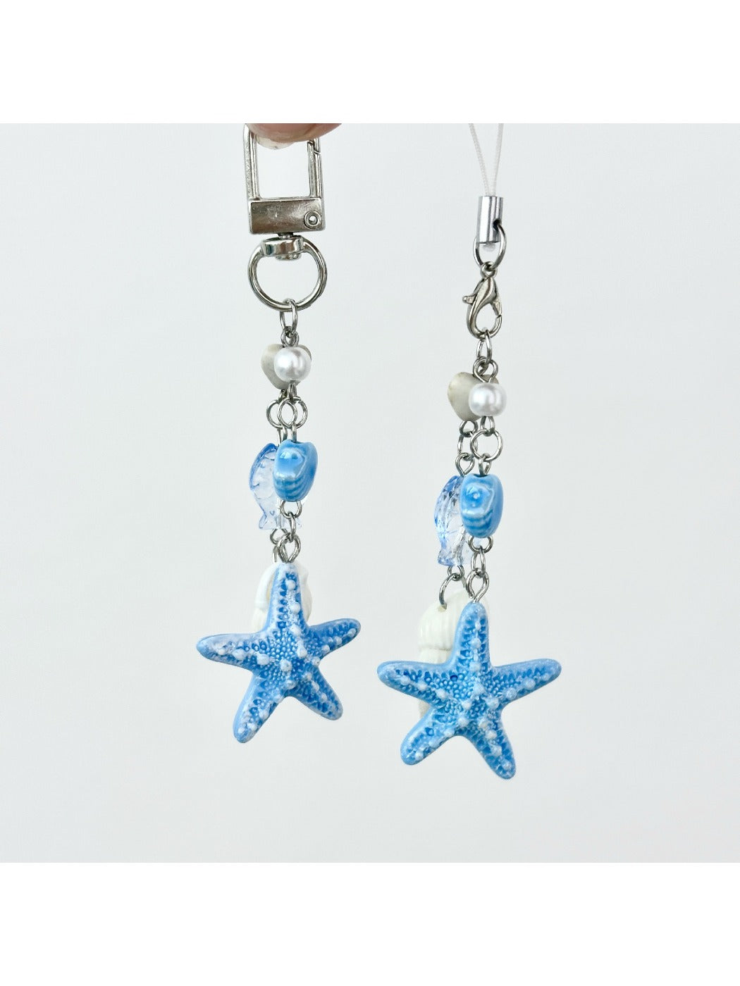 Starfish pendant keychain hanging from a bag zipper