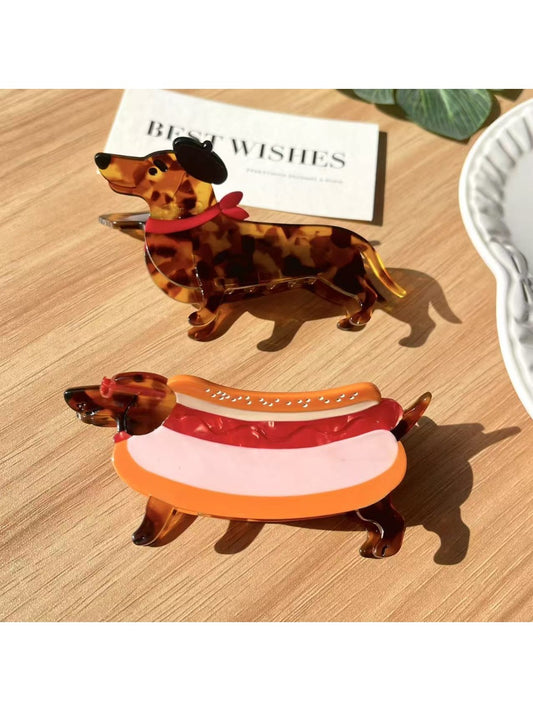 Beau cartoon dachshund shaped claw clip in brown and black colors on white background