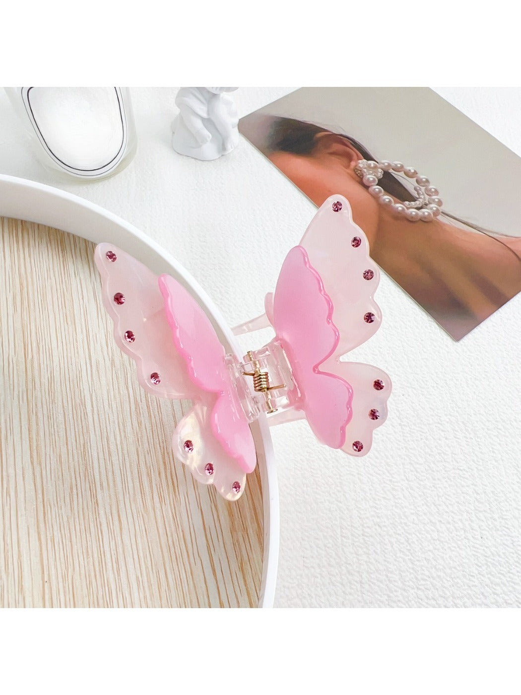 Butterfly claw clip displayed alongside matching pastel pink hair accessories