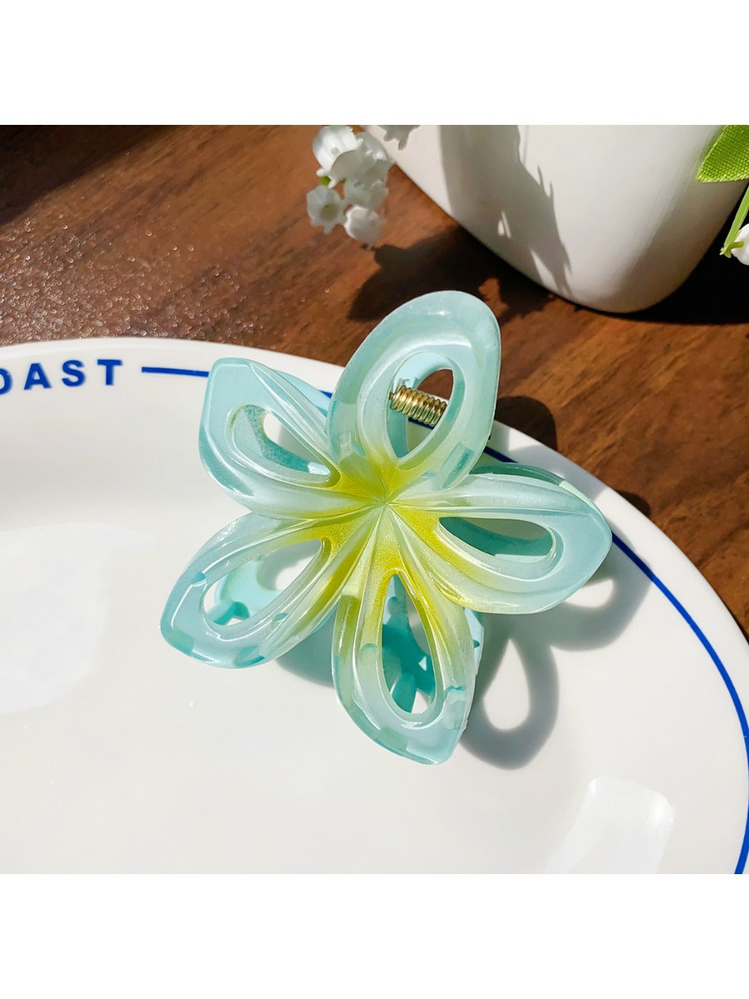 Top view of Beau openwork flower hair claw clip showing petal details