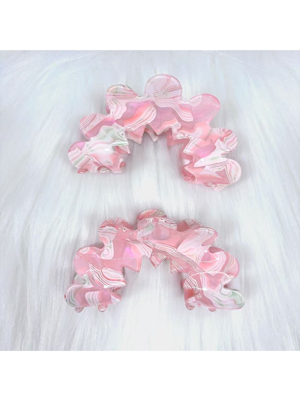 Close-up of Beau wavy pink hair clip with glossy finish on white background