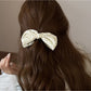 Beau elegant bow banana clip open, displaying curved teeth and clasp