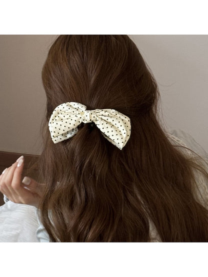 Beau elegant bow banana clip open, displaying curved teeth and clasp
