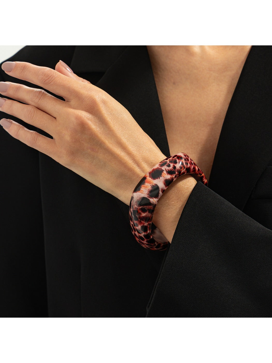 Lovra leopard print bangle bracelet displayed on a wrist with natural lighting
