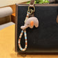 Elephant charm keychain photographed with natural outdoor lighting