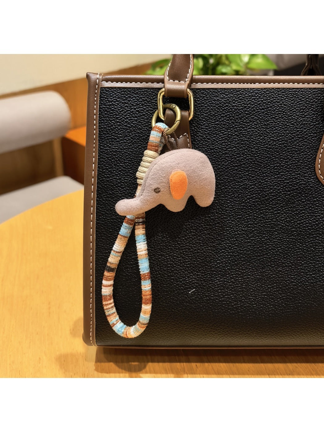 Elephant charm keychain photographed with natural outdoor lighting
