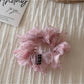 Multiple scrunchies stacked showing variety of floral patterns