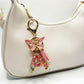 Hand holding the butterfly letter pendant keychain showing details