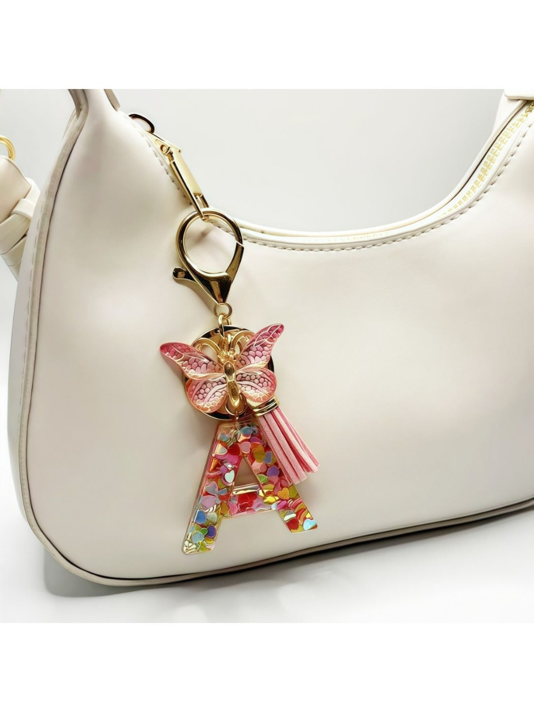 Hand holding the butterfly letter pendant keychain showing details