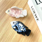 Side view of Beau fish shaped hair claw clip highlighting curved design